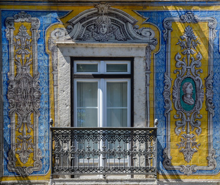 Typical portuguese window with ornamental tiles called "azulejos", made with colored ceramic tiles, in Lisbon, Portugalの写真素材