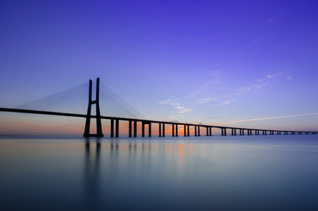 Sunrise at Vasco da Gama Bridge, the longest bridge in Europe, who spans the Tagus River, in Lisbon, Portugal.の写真素材