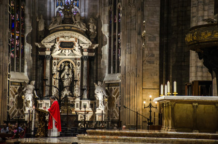 Milan/Italy-July 09, 2016: Priest preaching at the altar of Milan Cathedral, one of the biggest gothic cathedrals and famous tourist attraction in Lombardy, Italyのeditorial素材