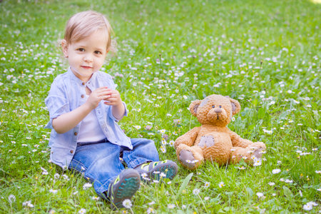 Cute little child and his mother playing in the parkの写真素材