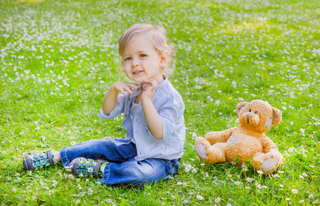 Cute little child and his mother playing in the parkの写真素材
