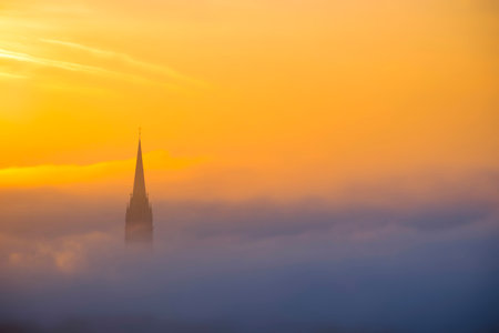 Cityscape of Graz with Church of the Sacred Heart of Jesus and historic buildings, in Graz, Styria region, Austria, at sunrise. Beautiful foggy morning over the city of Graz, in autumnの写真素材