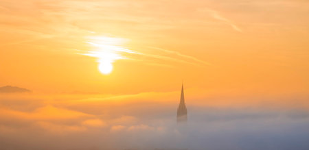 Cityscape of Graz with Church of the Sacred Heart of Jesus and historic buildings, in Graz, Styria region, Austria, at sunrise. Beautiful foggy morning over the city of Graz, in autumnの写真素材