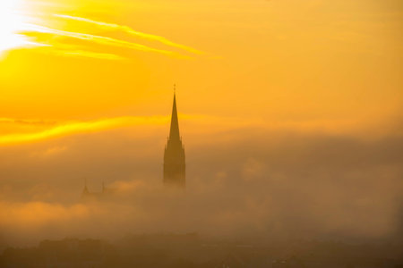 Cityscape of Graz with Church of the Sacred Heart of Jesus and historic buildings, in Graz, Styria region, Austria, at sunrise. Beautiful foggy morning over the city of Graz, in autumnの写真素材
