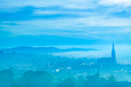 Cityscape of Graz with Church of the Sacred Heart of Jesus and historic buildings, in Graz, Styria region, Austria, at sunrise. Beautiful foggy morning over the city of Graz, in autumnの写真素材