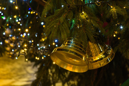 Colorful golden Christmas tree decorations and lights, at night.の写真素材