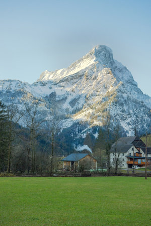 Winter landscape with snow covered Grimming mountain and Trautenfels Castle in the district of Liezen in Styria, Austriaの写真素材