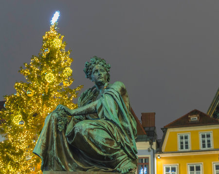 Main square Hauptplatz with Erzherzog Johann fountain and historical buildings, in winter by night, in Graz, Styria region, Austria.のeditorial素材