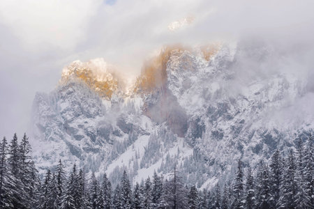 Jesus Christ on the cross against dramatic cloudy sky, at sunset. Crucifixion, religion and spiritualityの写真素材
