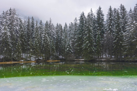 Jesus Christ on the cross against dramatic cloudy sky, at sunset. Crucifixion, religion and spiritualityの写真素材