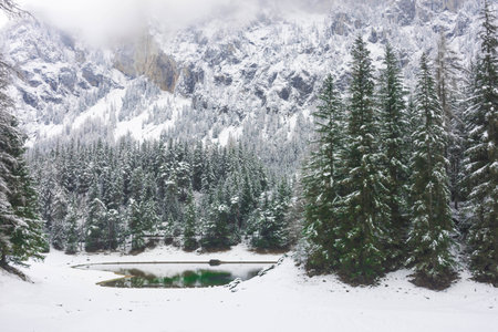 Amazing winter landscape with snowy mountains and clear waters of Green lake (Gruner see), famous tourist destination in Styria region, Austriaの写真素材