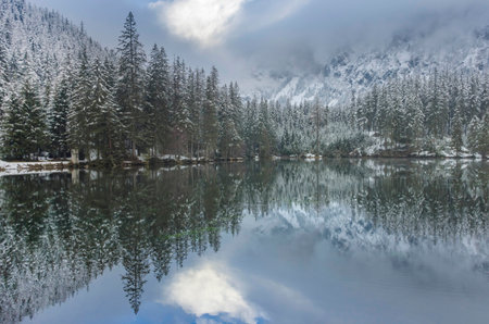 Amazing winter landscape with snowy mountains and clear waters of Green lake (Gruner see), famous tourist destination in Styria region, Austriaの写真素材