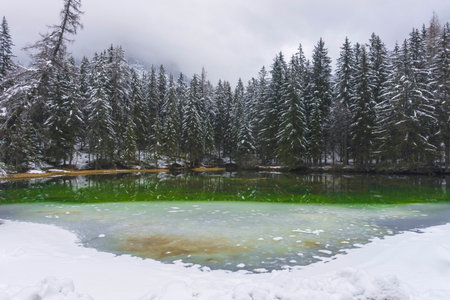 Amazing winter landscape with snowy mountains and frozen waters of Green lake (Gruner see), famous tourist destination in Styria region, Austriaの写真素材
