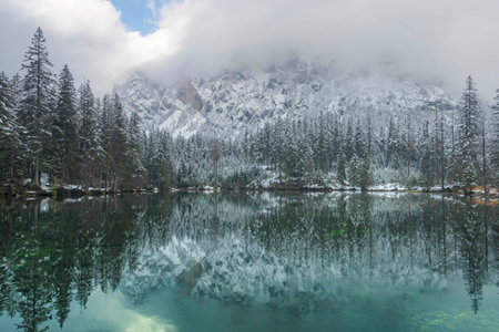Amazing winter landscape with snowy mountains and clear waters of Green lake (Gruner see), famous tourist destination in Styria region, Austriaの写真素材
