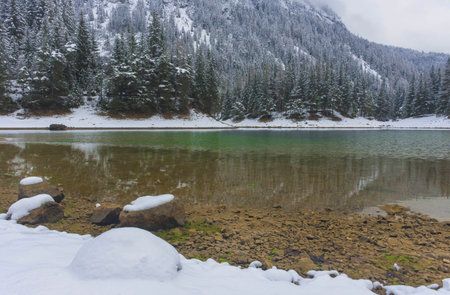 Amazing winter landscape with snowy mountains and clear waters of Green lake (Gruner see), famous tourist destination in Styria region, Austriaの写真素材