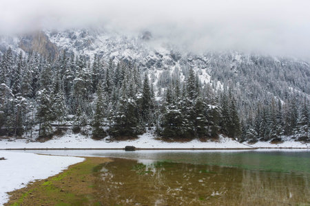 Amazing winter landscape with snowy mountains and clear waters of Green lake (Gruner see), famous tourist destination in Styria region, Austriaの写真素材