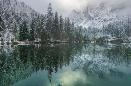 Amazing winter landscape with snowy mountains and clear waters of Green lake (Gruner see), famous tourist destination in Styria region, Austriaの写真素材