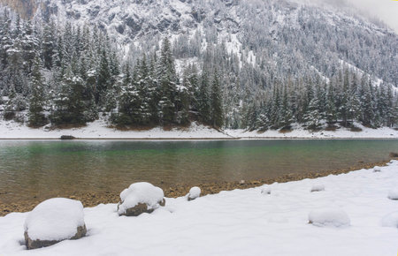 Amazing winter landscape with snowy mountains and clear waters of Green lake (Gruner see), famous tourist destination in Styria region, Austriaの写真素材