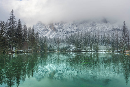 Amazing winter landscape with snowy mountains and clear waters of Green lake (Gruner see), famous tourist destination in Styria region, Austriaの写真素材