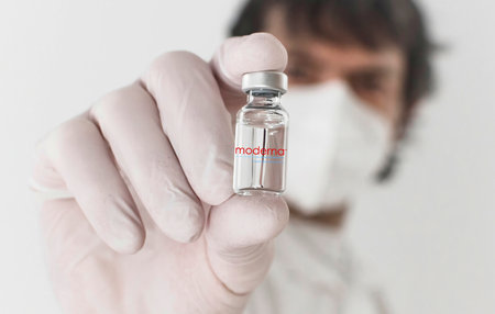 Graz,Austria-26.01.2021: Doctor holding a vaccine bottle and syringe, beginning of mass vaccination with the Moderna COVID-19 vaccine, coronavirus world immunization conceptのeditorial素材