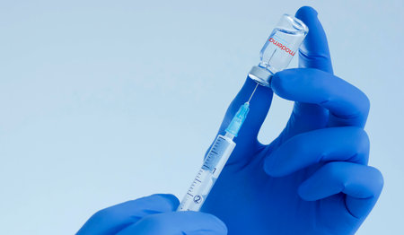 Graz, Austria-26.01.2021: Doctor hands holding a Moderna vaccine bottle and syringe, beginning of mass vaccination for coronavirus COVID-19, world immunization conceptのeditorial素材
