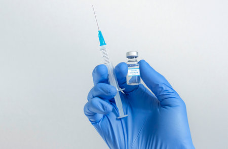 Doctor hands holding a vaccine bottle and syringe,beginning of worldwide mass vaccination for coronavirus COVID-19,influenza or flu,world immunization concept. Selective focusの写真素材
