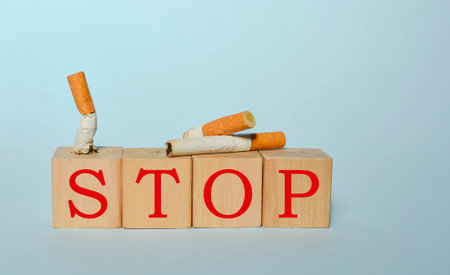 Stop smoking concept, cigarettes and STOP text on wooden blocks. World No Tobacco Day on May 31 concept. Selective focusの写真素材