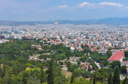 View of the Athens and the ancient Temple of Hephaestus, a doric greek temple in the north-west side of the Agora of Athens, Greece.の写真素材