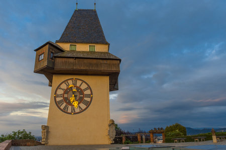 The famous clock tower (Grazer Uhrturm) and gardens on Shlossberg hill before sunrise,in Graz, Styria region, Austriaのeditorial素材