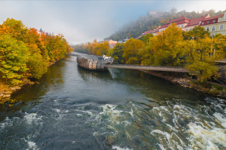 Mur river in autumn, with Murinsel bridge and old buildings in the city center of Graz, Styria region, Austria.のeditorial素材