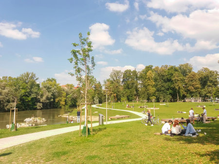 Graz, Austria-14.09.2020: people relaxing outdoor in a park near Mur river, in summer, Styria region, Austria. Selective focus.のeditorial素材