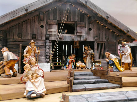 Traditional Christmas nativity scene with beautiful figures made out of wood. The birth of Jesus Christ in the manger surrounded by Joseph, Mary and the Magi.の写真素材