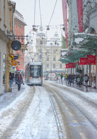 Graz, Austria-December 09, 2021: People walking through heavy snow and the Town Hall building in the background, in the city center of Graz, Steiermark, Austria, in winter dayのeditorial素材