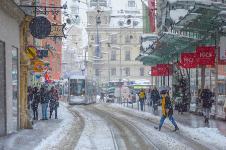 Graz, Austria-December 09, 2021: People walking through heavy snow and the Town Hall building in the background, in the city center of Graz, Steiermark, Austria, in winter dayのeditorial素材