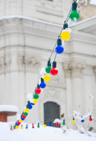 Colored light bulbs, Christmas decorations in winter snowy day. Selective focusの写真素材