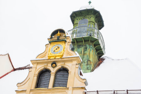 Detail of an old historical building (Gottfried Maurer House) in Glockenspielplatz Square in Graz, Steiermark, Austria, with snow, in winterの写真素材