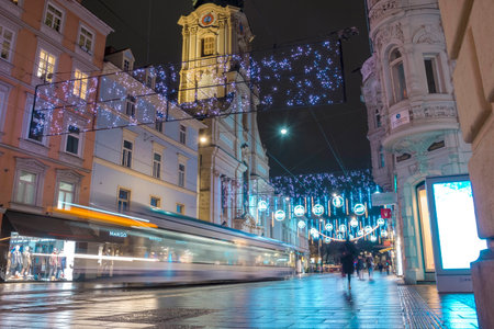 Graz, Austria-December 02, 2021: Beautiful Christmas decorations and lights on famous Herrengasse street, at night, in the city center of Graz, Steiermark, Austria. Selective focusのeditorial素材