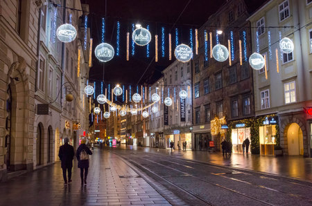 Graz, Austria-December 02, 2021: Beautiful Christmas decorations and lights on famous Herrengasse street, at night, in the city center of Graz, Steiermark, Austria. Selective focusのeditorial素材