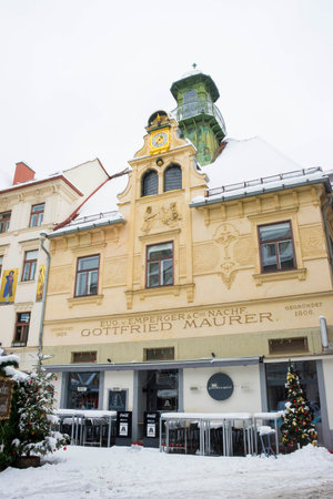 Graz, Austria-December 09, 2021: Old historical building (Gottfried Maurer House) in Glockenspielplatz Square in Graz, Steiermark, Austria, with snow, in winterのeditorial素材