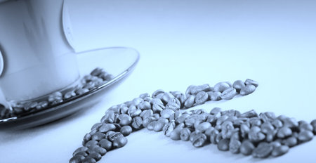 Cup with coffee, costing on coffee grain.の写真素材