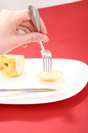 Eating a tasty yellow pear.の写真素材