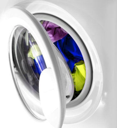 Colorful shirt and trousers in a white laundry.の写真素材
