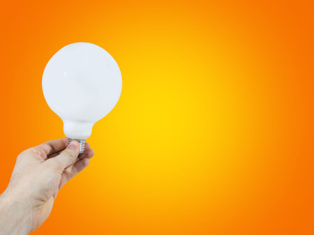 White bulb in a man's handの写真素材