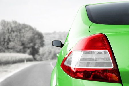 Car detail - back side, half. On the road.の写真素材