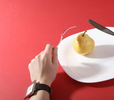 Eating a tasty yellow pear.の写真素材