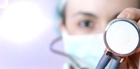 Female doctor with mask and stethoscope.の写真素材