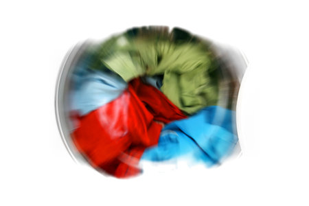 Colorful shirt and trousers in a white laundry.の写真素材