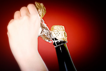 Woman hands opening champagne bottleの写真素材