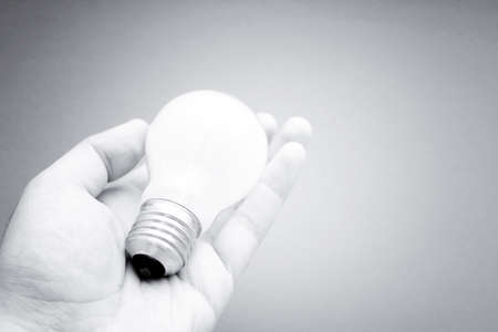 Background with lit lightbulb. Isolated on redの写真素材