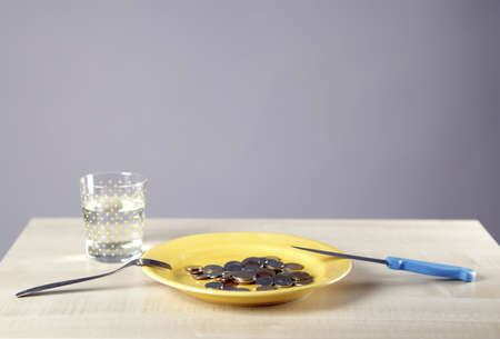 Many Euro coins in a yellow plate.の写真素材